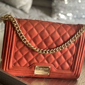 BEBE BURNT ORANGE GOLD CHAIN STRAP HANDBAG